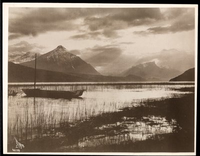 View of a lake and a boat during the construction of the Panama Canal by Byron Company